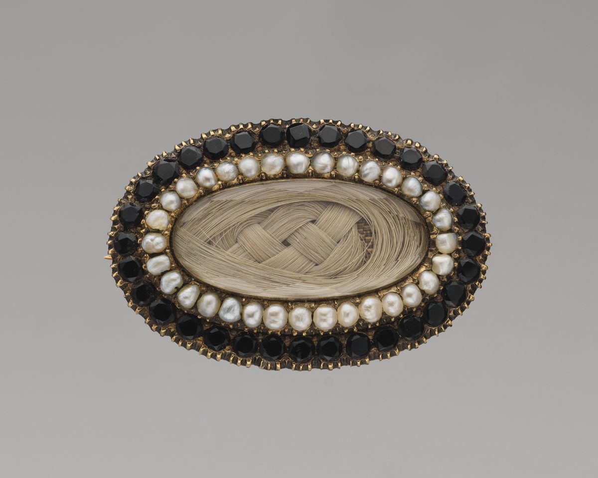 Public-domain Met photograph of a gold, jet, pearl, crystal and hair mourning brooch