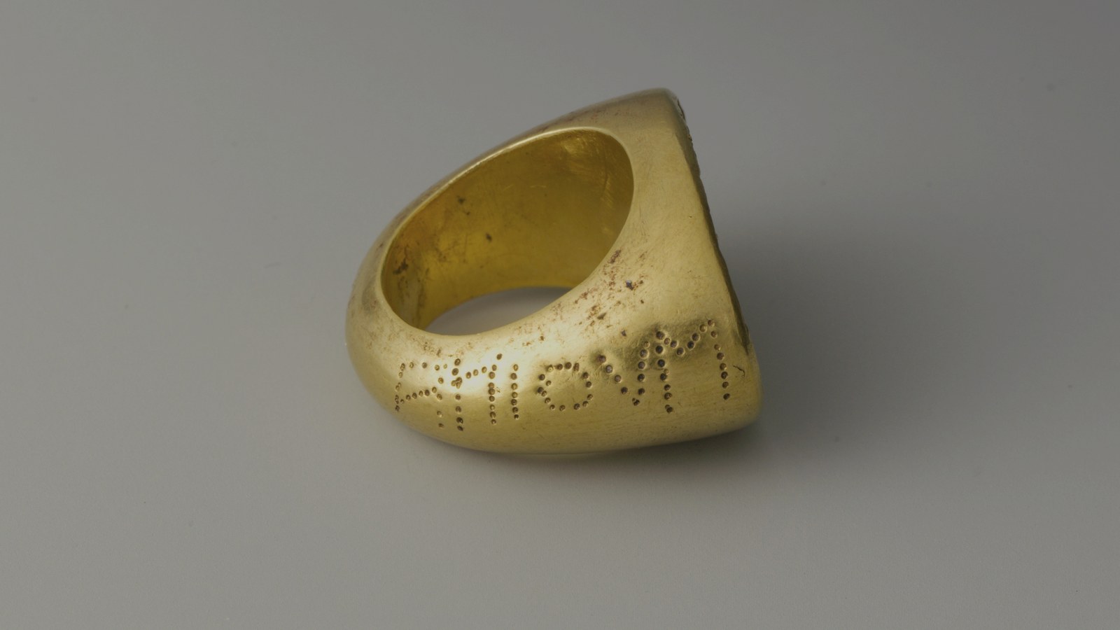 Ancient gold ring with lettering on the band