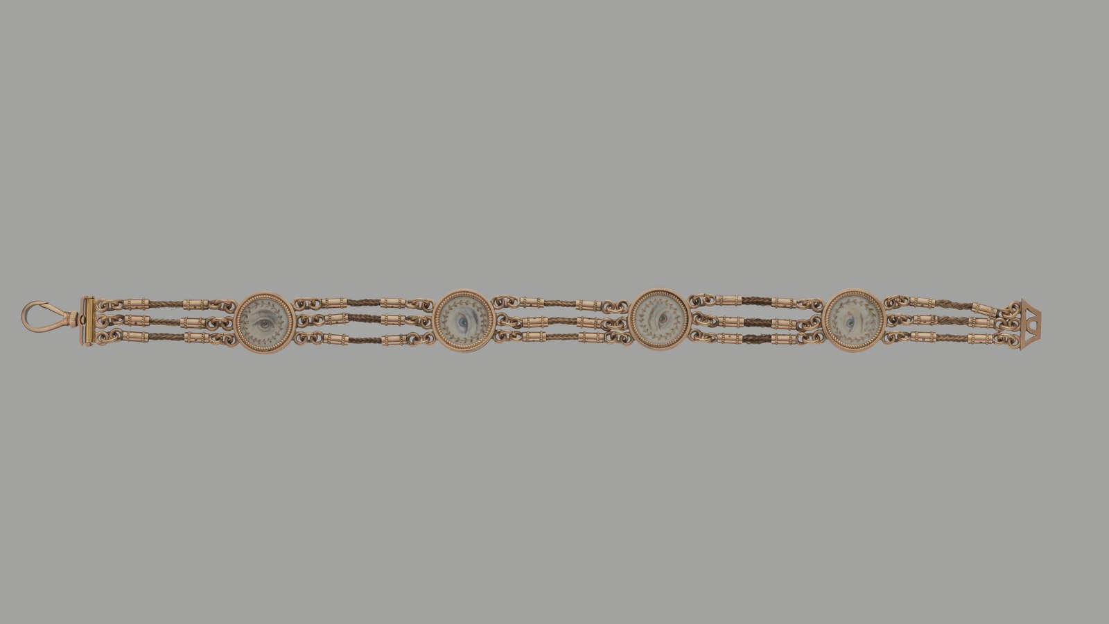 Gold watch fob set with painted lover's eyes, about 1820