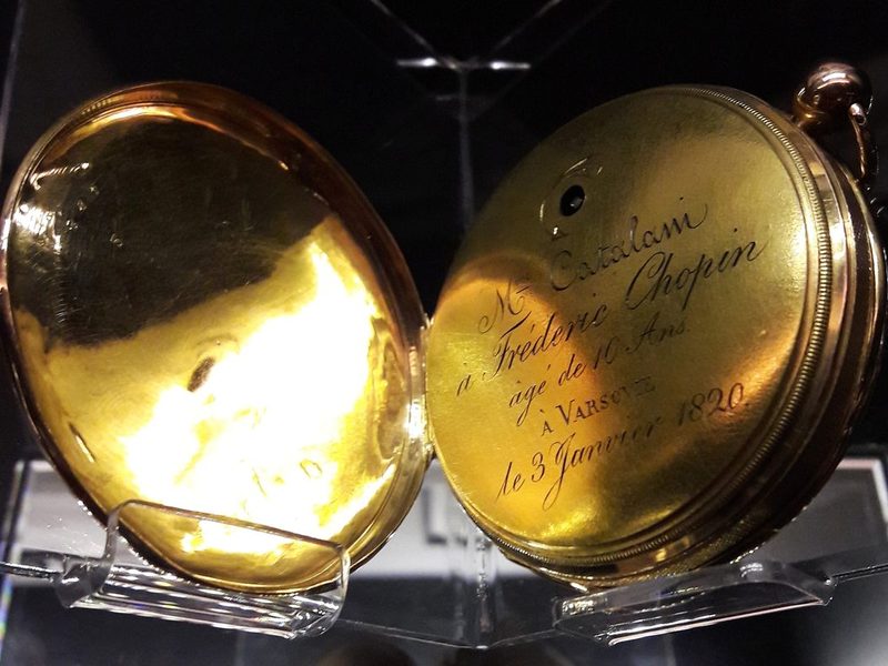 Engraved gold pocket watch from 1820, open to show the inscription